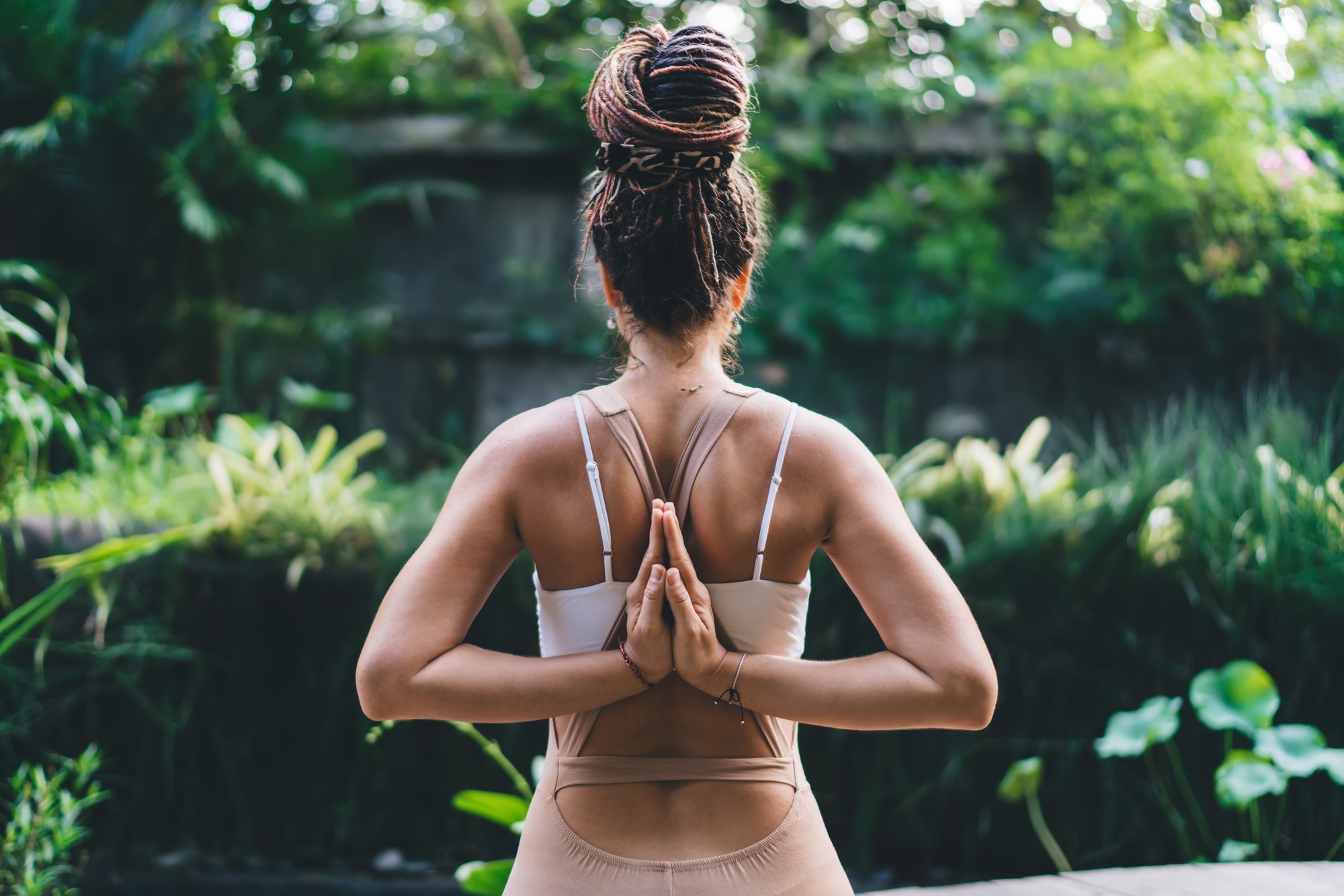 Unrecognizable woman doing yoga exercise in green park